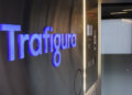 Illuminated sign displaying the name 'Trafigura' in a modern office setting.