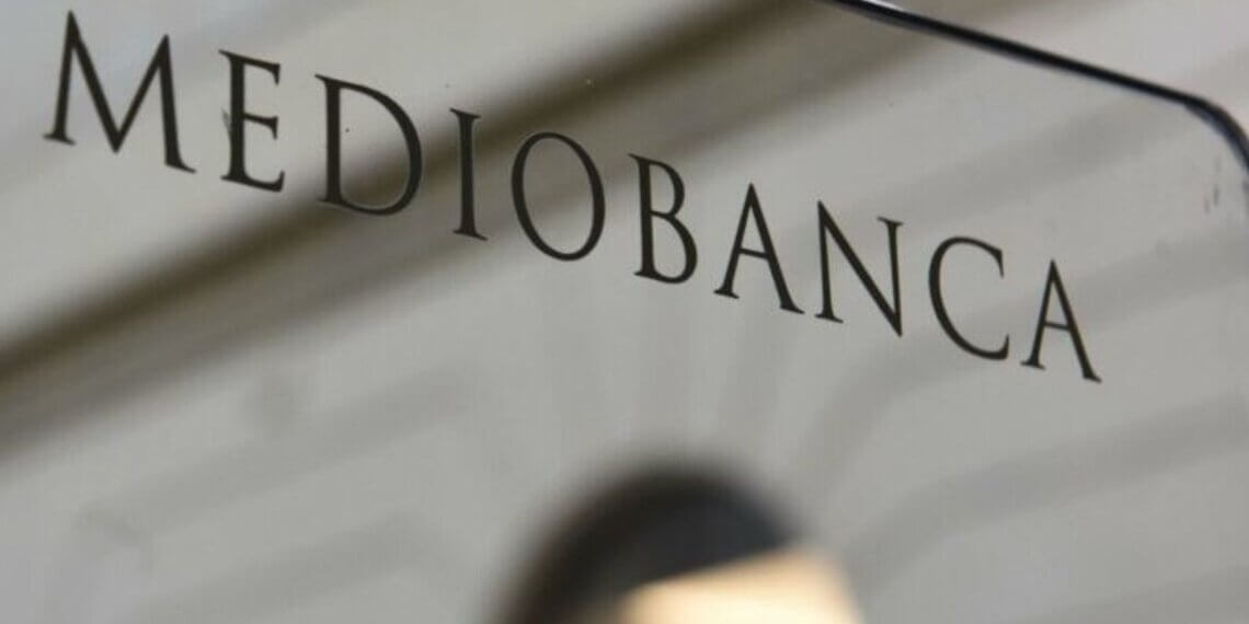 Sign displaying the name 'Mediobanca' on a glass surface.