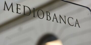 Sign displaying the name 'Mediobanca' on a glass surface.