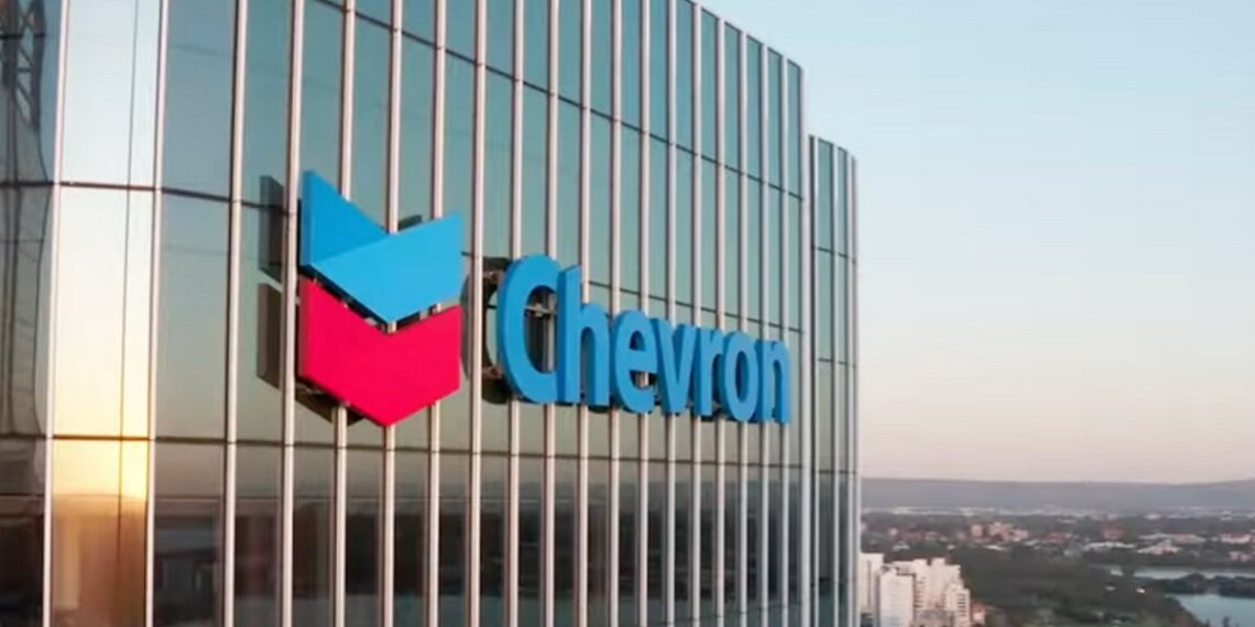 Chevron logo displayed on the exterior of a corporate building with glass panels.