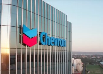 Chevron logo displayed on the exterior of a corporate building with glass panels.