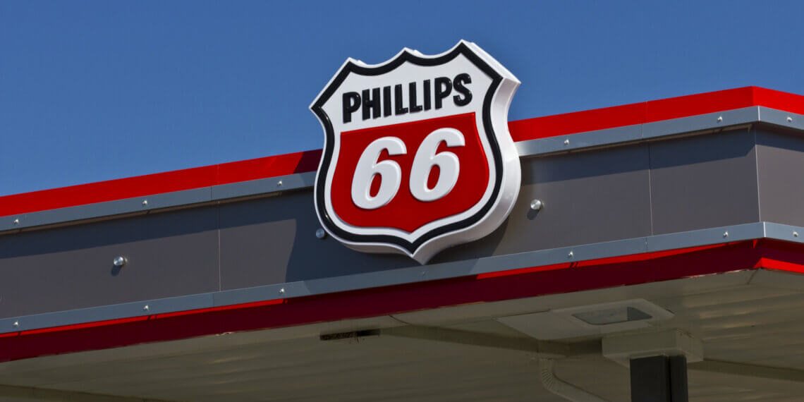 Phillips 66 logo displayed on the roof of a gas station under a clear blue sky.