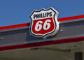 Phillips 66 logo displayed on the roof of a gas station under a clear blue sky.
