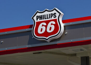 Phillips 66 logo displayed on the roof of a gas station under a clear blue sky.