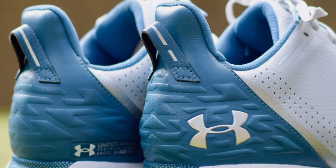 Close-up view of the back of Under Armour HOVR Drive spikeless golf shoes in blue and white.