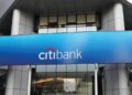 CitiBank logo displayed on a blue sign above the entrance of a building.
