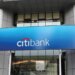 CitiBank logo displayed on a blue sign above the entrance of a building.