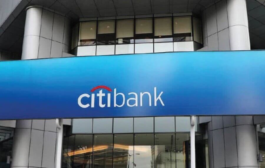 CitiBank logo displayed on a blue sign above the entrance of a building.