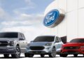 Three Ford vehicles displayed in front of a Ford logo on a building.